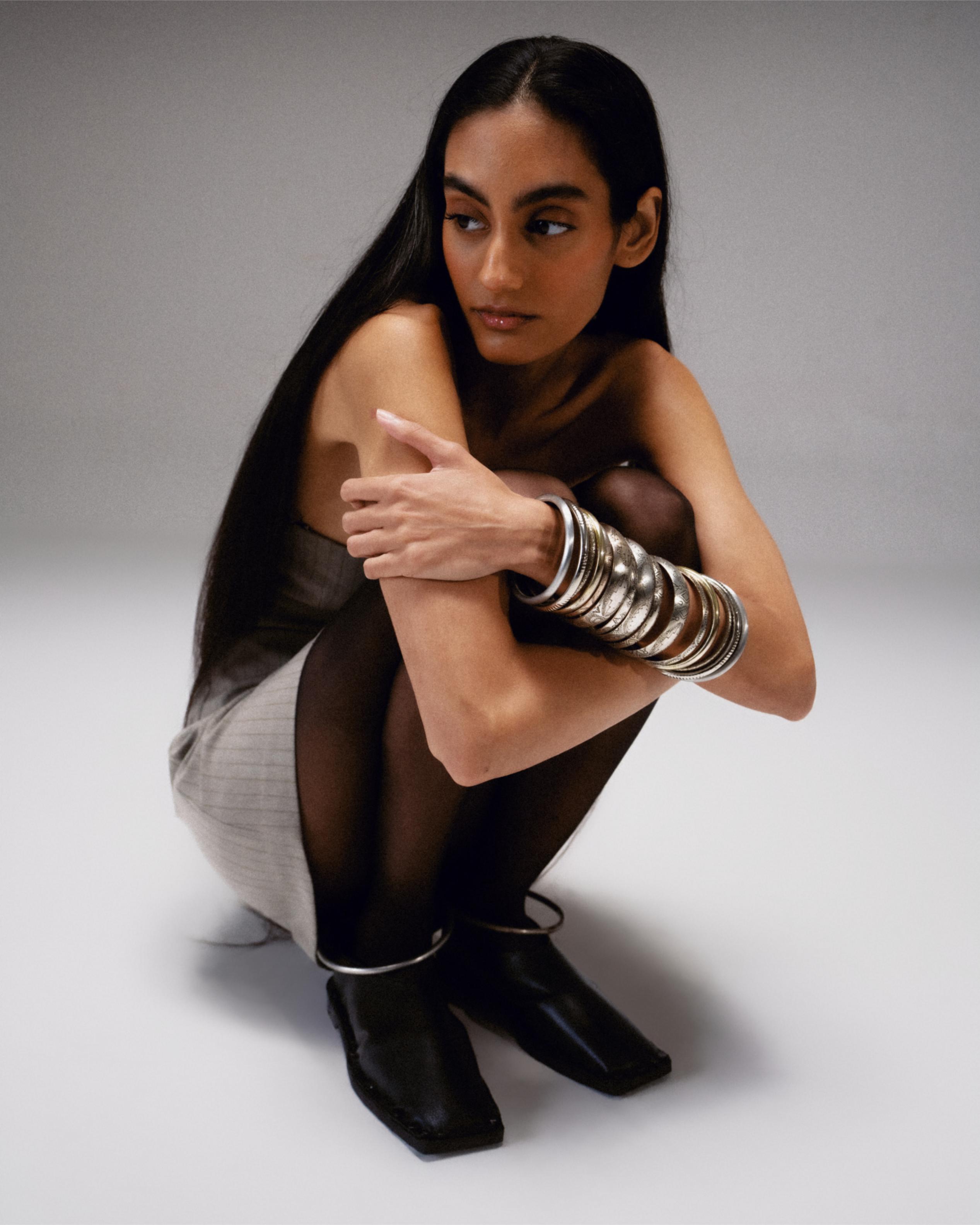 Black Vegan Leather Gladiator Flats Defined by a Circular Ankle Hold