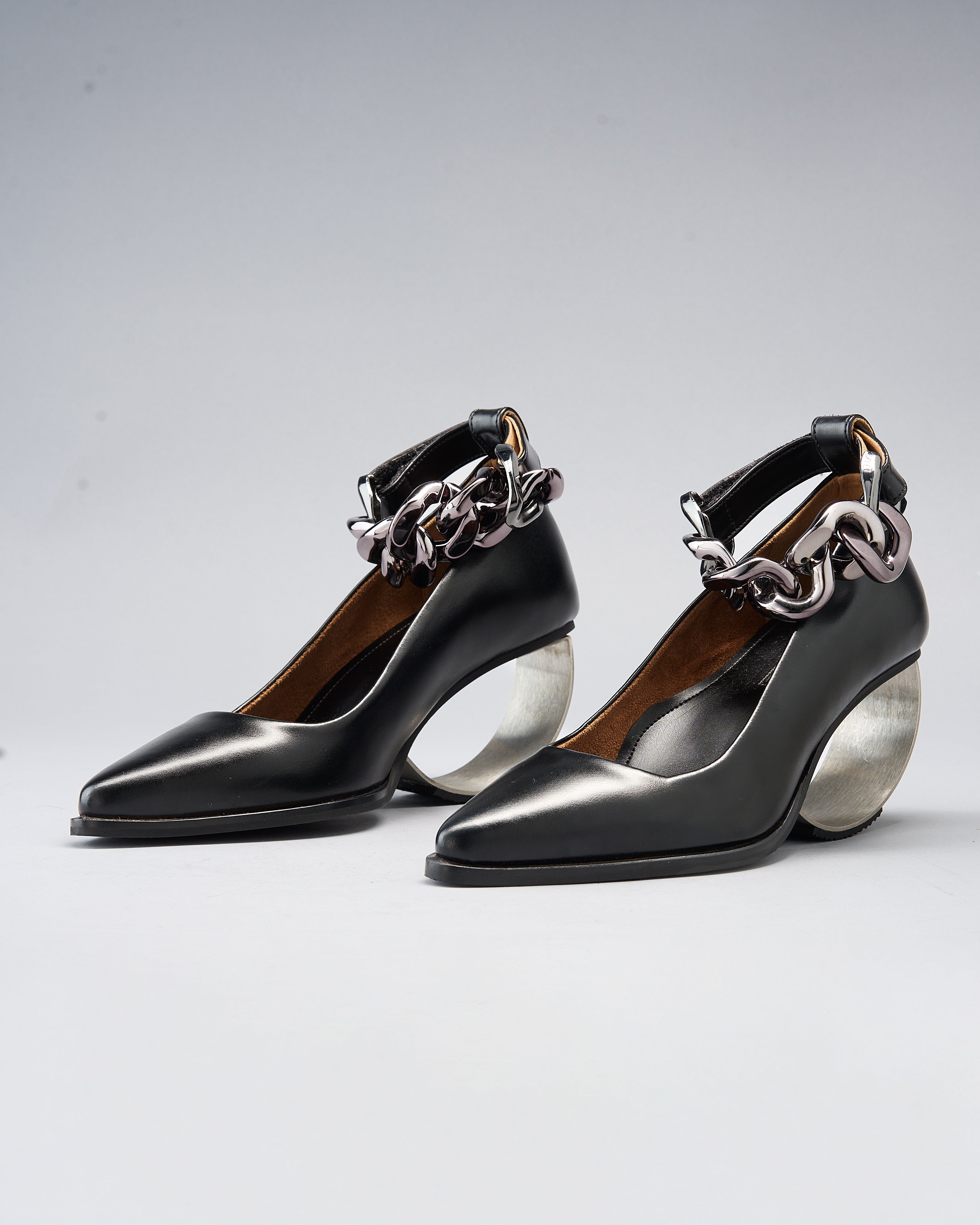 Sculptural Plant Leather Shoe grounded by a Steel Arc Heel and Secured with a Chain