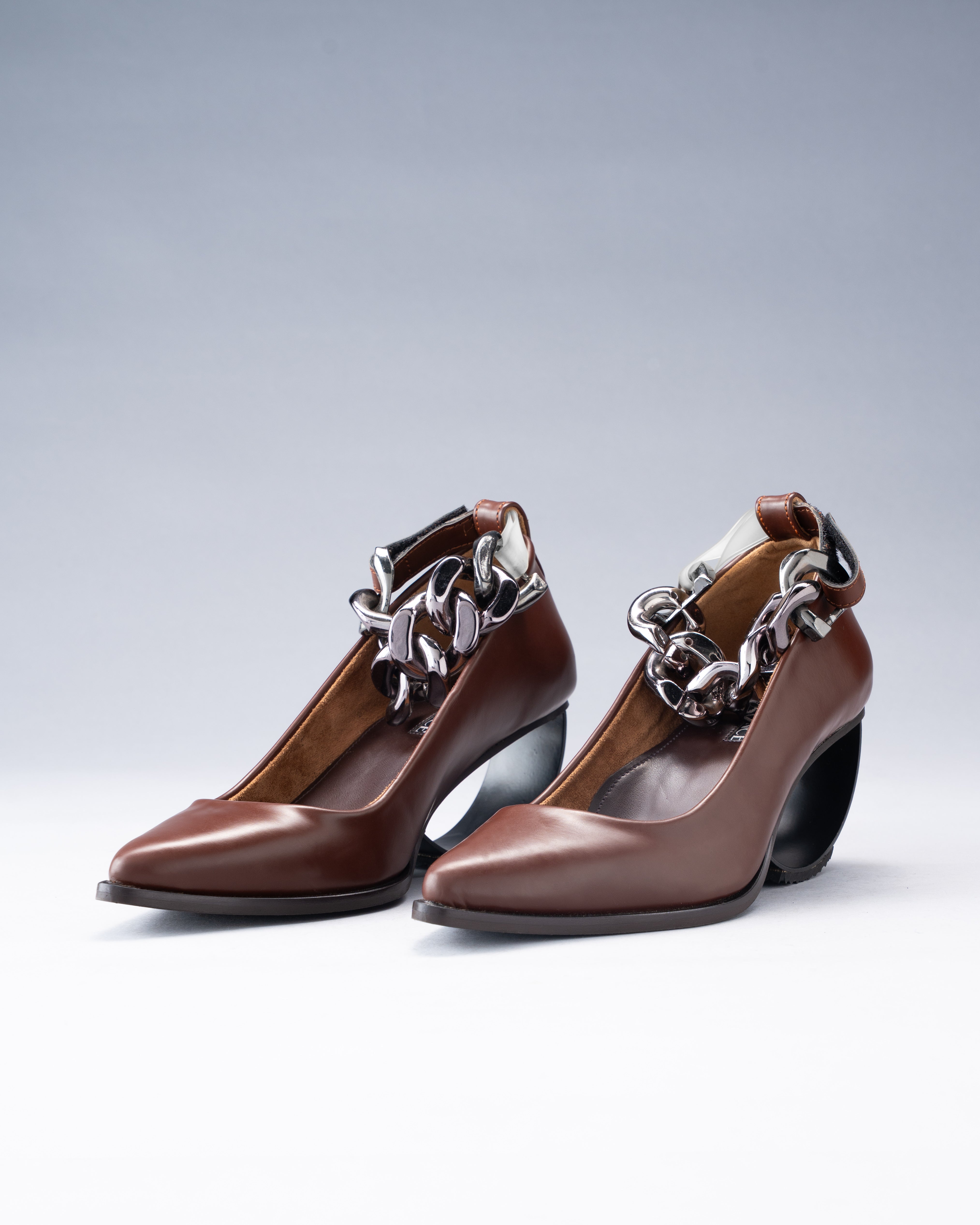 Sculptural Plant Leather Shoe grounded by a Steel Arc Heel and Secured with a Chain