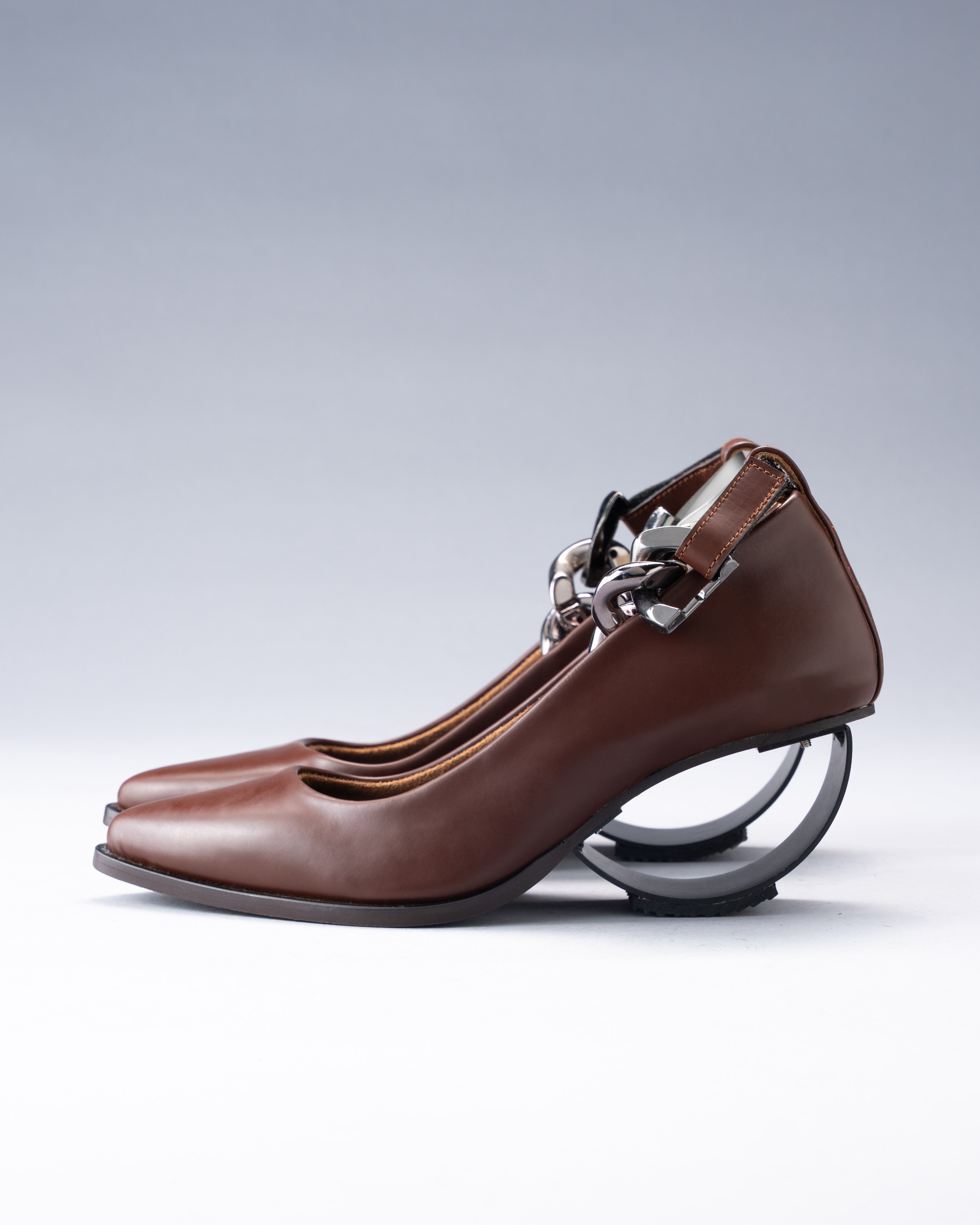 Sculptural Plant Leather Shoe grounded by a Steel Arc Heel and Secured with a Chain