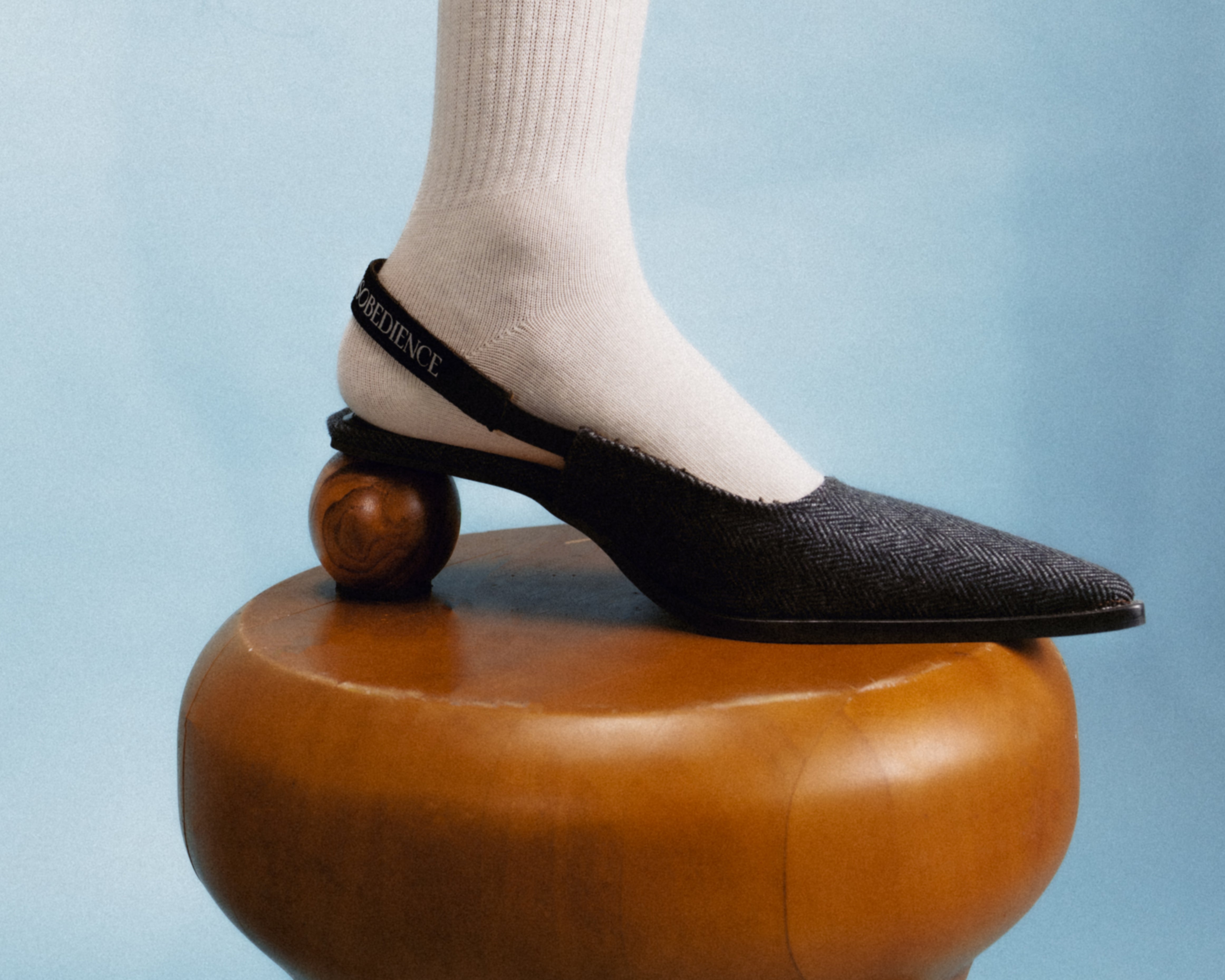 Sling-Back Sandal Balanced on a Spherical Teak Heel