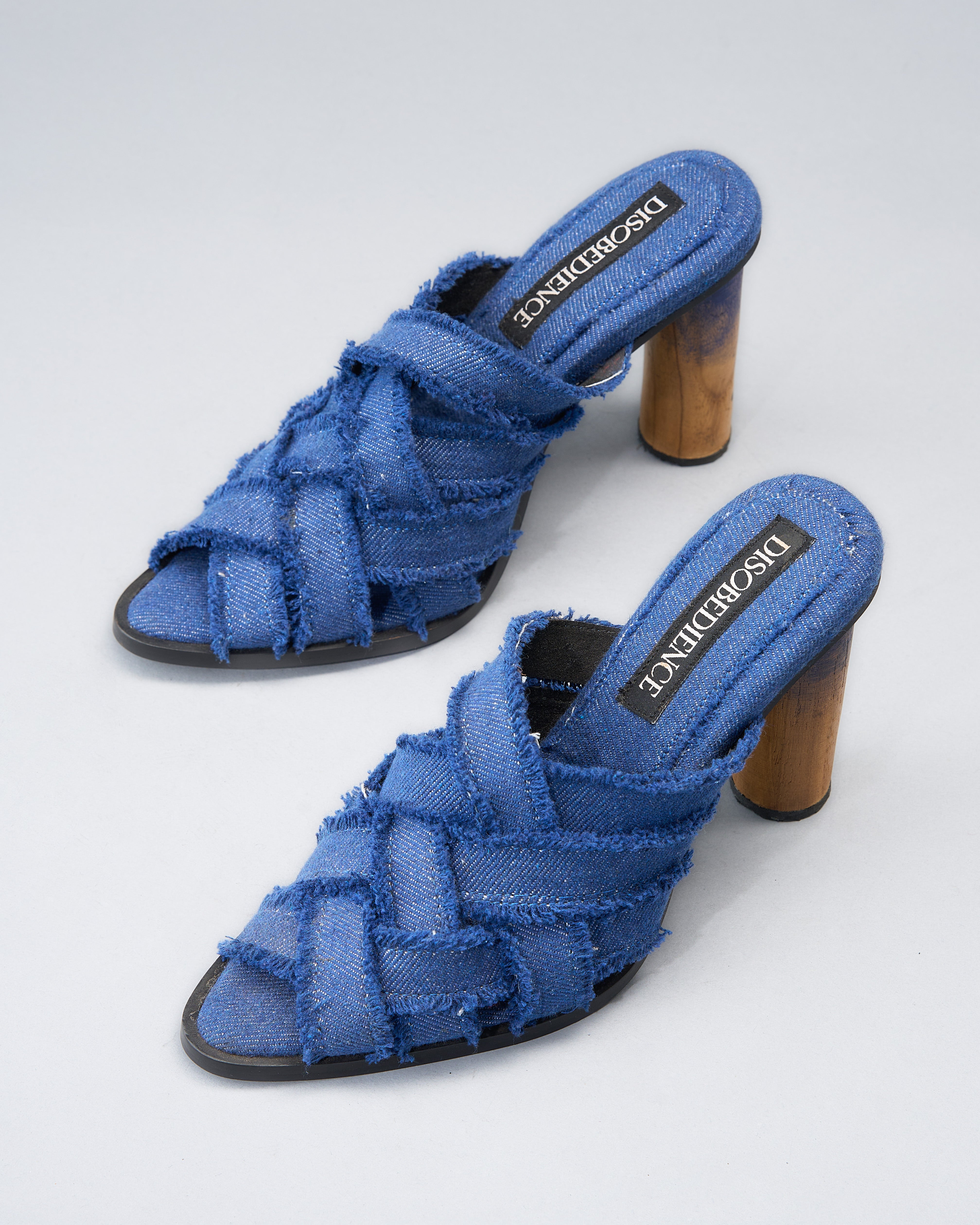 handwoven denim sandal crafted from recycled cotton, grounded by a hand-built teak wood heel