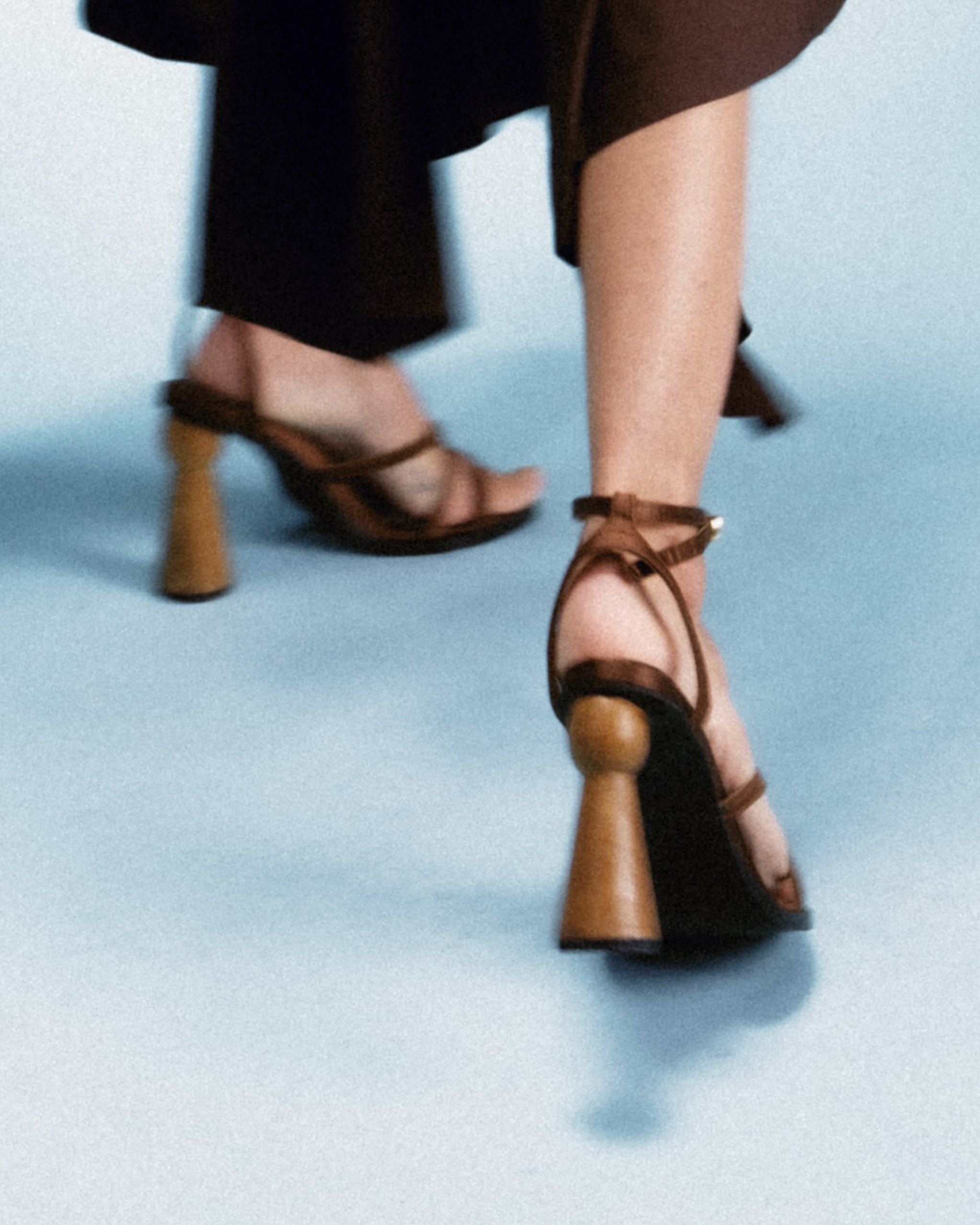strappy sandal elevated by a hand-turned wooden heel, shaped like a goblet for balance and visual drama